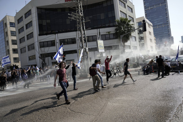 Israeli police deploy a water cannon to disperse Israelis blocking a main road to protest Prime Minister Benjamin Netanyahu’s plans to overhaul the nation’s judicial system.