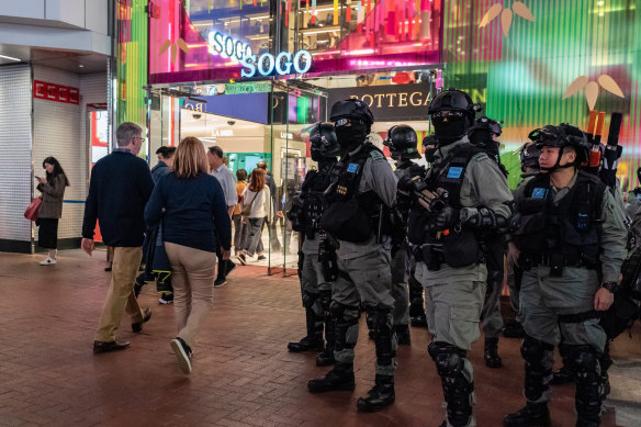 Riot police stand guard outside a department store in Causeway Bay.