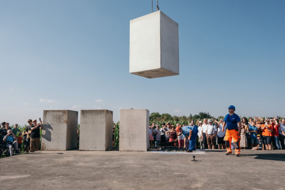 A crowd gathers outside the town of Wemding, in southern Germany, to see the latest stage in the construction of the “Time Pyramid,” a public artwork.