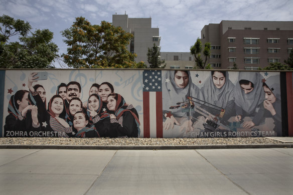 A mural along the walls of the US embassy in Kabul, Afghanistan, features the women’s robotic team (right).