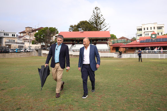 Eddie Jones and Rugby Australia head of communications Mark McCartney walk out to inspect the Coogee Oval pitch.