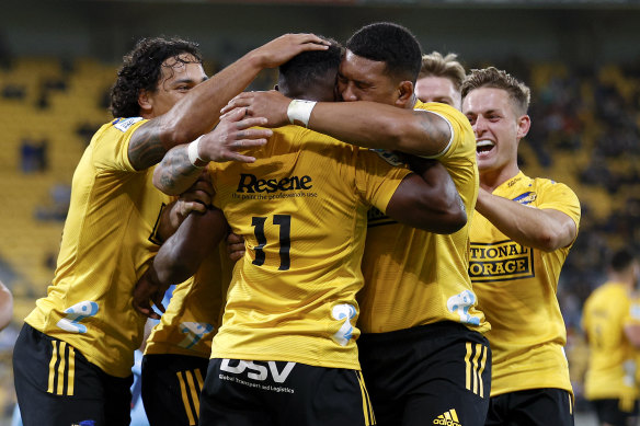 The Hurricanes congratulate two-try rookie Kini Naholo.