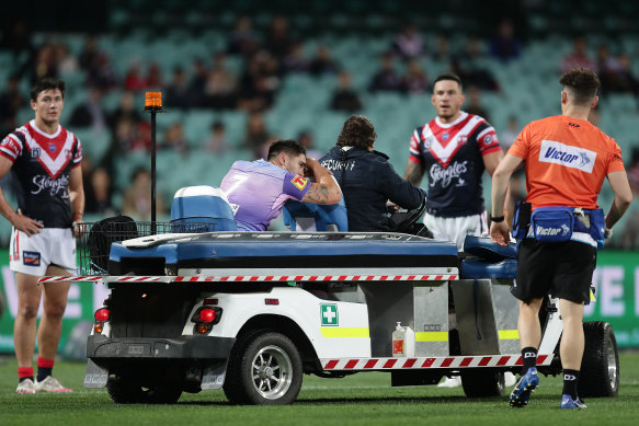 Shaun Johnson leaves the field on a medicab.