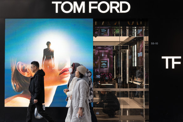 People walk past a store of American luxury brand Tom Ford in Beijng’s Sanlitun shopping district.