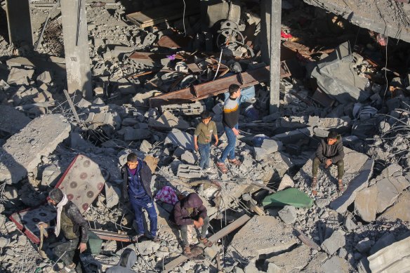 People inspect the damage to their homes following Israeli airstrikes on Rafah, Gaza.