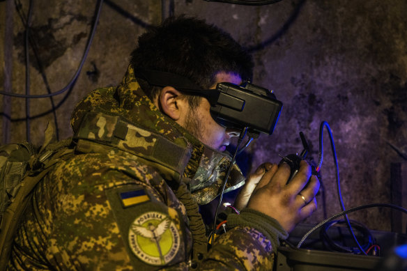 A Ukrainian soldier remotely pilots an FPV drone from an underground bunker.
