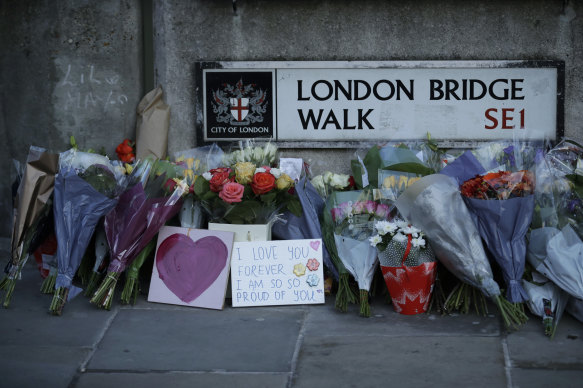 Tributes are placed by the southern end of London Bridge, three days after a man stabbed two people to death and injured three others before being shot dead by police in London..