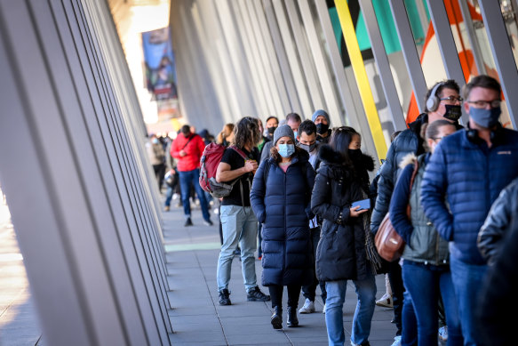 Safety first: People queue up for COVID-19 vaccination at the Melbourne convention centre.