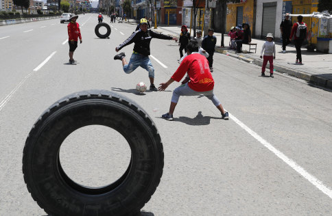 Children play soccer in El Alto, on the outskirts of La Paz, on Sunday. Cars are banned and shops are closed during national elections.