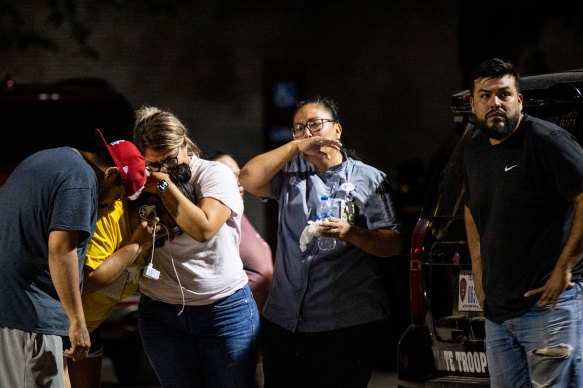 A family grieves outside of the civic centre following the mass shooting at Robb Elementary School.