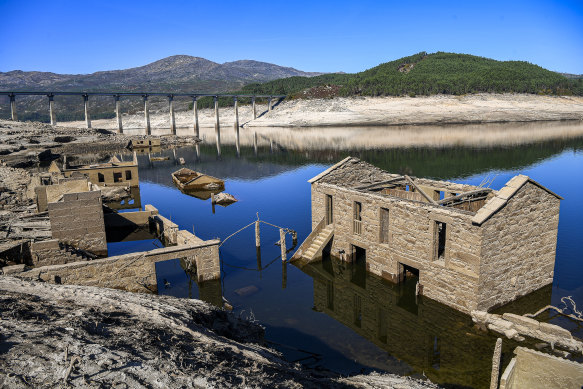 The dam’s high watermark is visible on the far side.