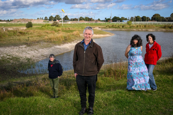 Bruce Cutts of the Glen Eira Emergency Climate Action Network and local residents Sally Clarke, Rachael Vassallo with her mother Helen Fischer, in front of the Southern Lake inside the Caulfield Racecourse Reserve.