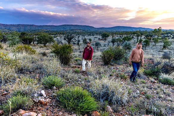 Traditional owner Damien Kunoth (Arrernte) with son Byson on country outside Alice Springs.