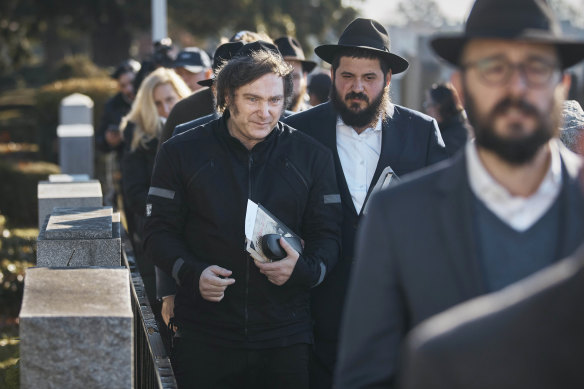 Argentina’s president-elect, Javier Milei, centre, leaves after praying next to rabbis at the resting place of Rabbi Menachem Mendel Schneerson in New York.
