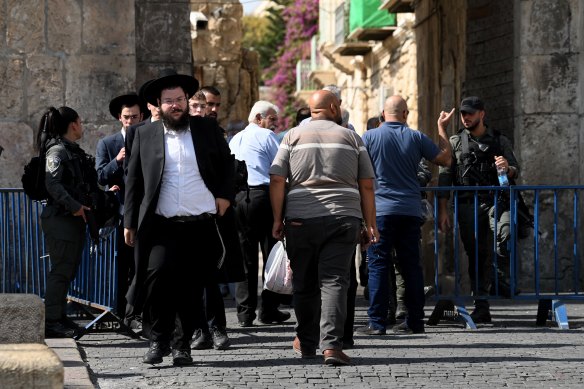 Muslim worshippers wait to pass through security checks to enter the Al Aqsa Mosque in Jerusalem.