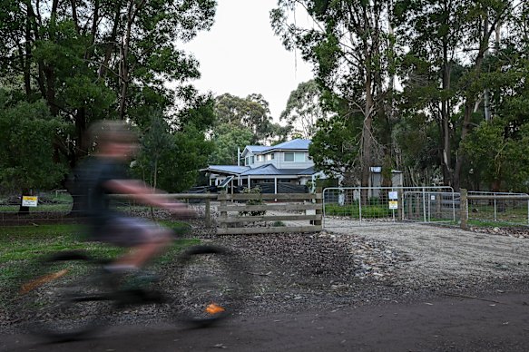 A boy rides past Erin Patterson’s home in Leongatha.