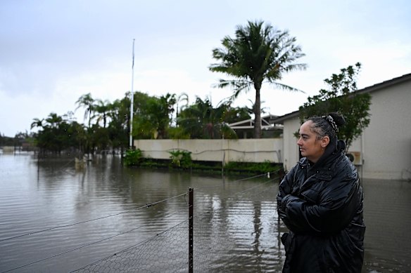 Kerri-Ann Gimbert at her neighbour’s property in Pampoolah where her deer have sought refuge. Her home has been flooded. 