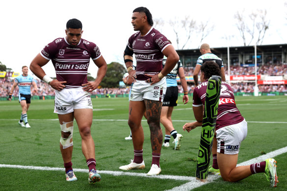 Tolutau Koula, Haumole Olakau’atu and Clayton Faulalo of Manly react after Ronaldo Mulitalo scores.