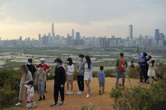 Hong Kong citizens on the border, with China’s Shenzhen in the background. 