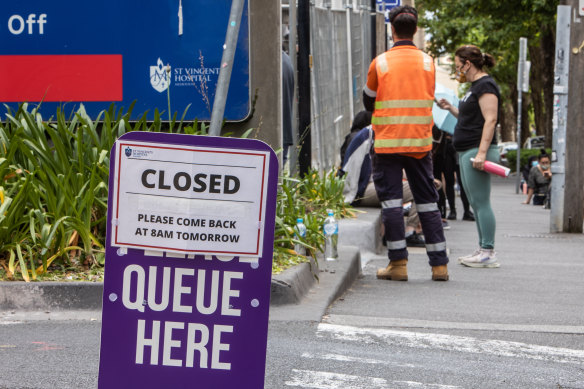  A sign reading “CLOSED - Please come back at 8am tomorrow” outside the St Vincent’s Hospital COVID-19 testing centre in Fitzroy early on Sunday morning. 