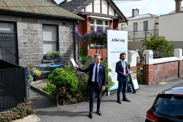 Jellis Craig Fitzroy partner and auctioneer Charles Atkins asks for buyers for their best offers during the auction for the terrace.
