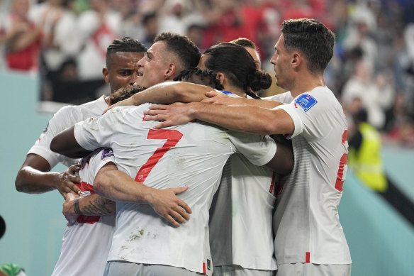 Switzerland players celebrate with teammate Xherdan Shaqiri after he scored his side’s opening goal.