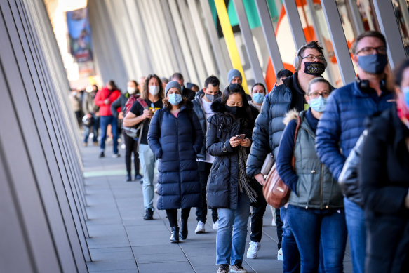 People queue up for COVID-19 vaccination at the Melbourne Convention and Exhibition Centre early on Wednesday morning.