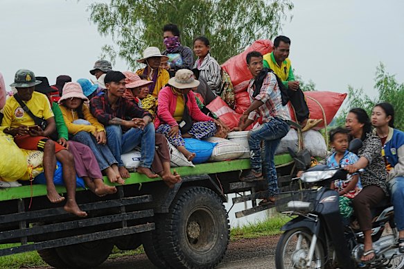 Cambodians sit on a cart of a tractor as they take refuge in Oddar Meanchey province, Cambodia, on Saturday.