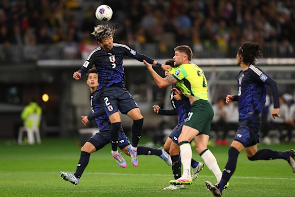 Hiroki Sekine of Japan heads the ball