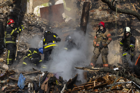 Firefighters at a four-storey residential building after a “kamikaze drone” attack in Kyiv on Monday.