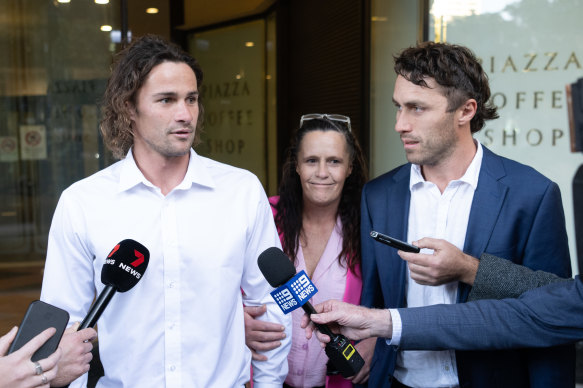 Nicho Hynes leaves court with his mother, Julie, and older brother Wade