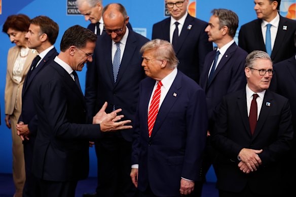 Donald Trump (centre) speaks with NATO secretary-general Mark Rutte (left). 