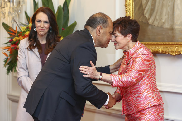 Prime Minister Jacinda Ardern looks on as Willie Jackson greets Governor-General Dame Patsy Reddy with a hongi (a traditional Maori greeting) during the ministerial swearing-in ceremony.