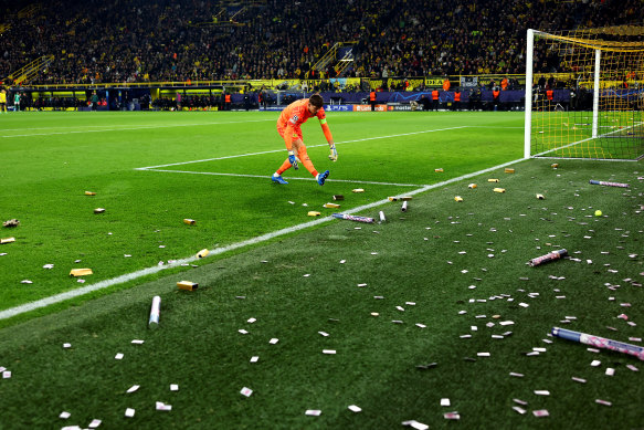 Dortmund keeper Gregor Kobel looks on as fake money is thrown onto the pitch during the win over Newcastle.