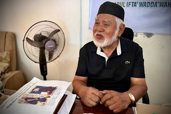 Sheikh Muhammad Yusop Pasigan in his office in Davao City with a printout about the Bondi shooters. 