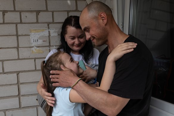 Viktor Kryvolapchuk with daughter Milana, 8, and his wife, Iryna, after spending 22 months in Russian captivity.