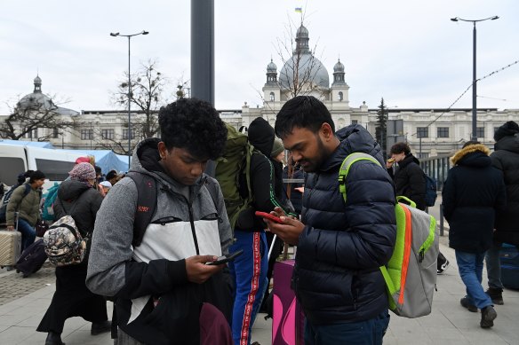 Indian doctors Agnivesh Sl (left) and Javeen Kolar arrive at Lviv railway station after their friend was killed by shelling in Kharkiv.