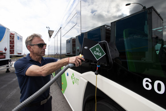 A driver fills the tank of an urban bus with green hydrogen at the bus depot of the municipal transport company in Palma de Mallorca.