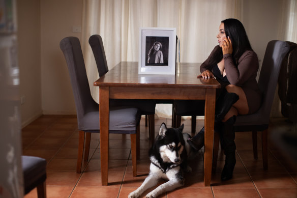 Georgia Wilson looks at a photo her mother, Kaye, who died in a Melbourne care home.