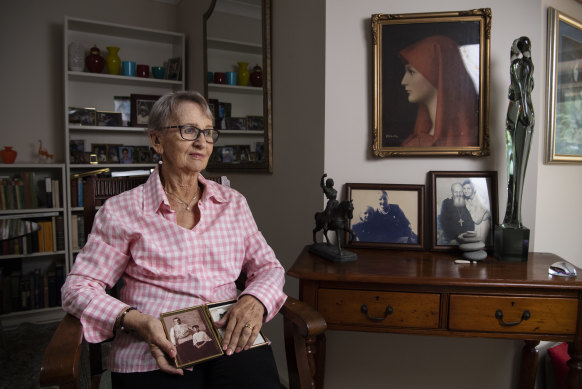 My mother in her Central Coast home, holding a photo of her late mother and father. 