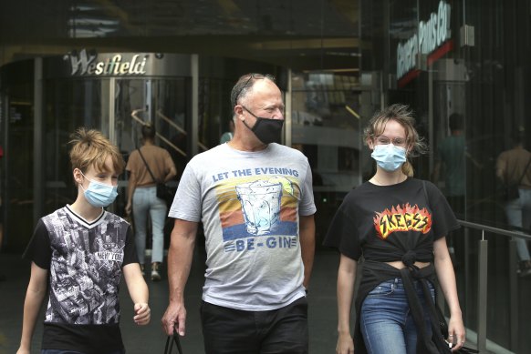 Ben Loiterton, with two of his children at Bondi Junction, says wearing a mask is necessary to protect the community's health and the economy.