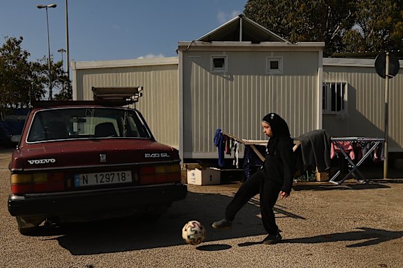 A young girl kicks a soccer ball at a shelter at the Quarantina near the Port of Beirut.