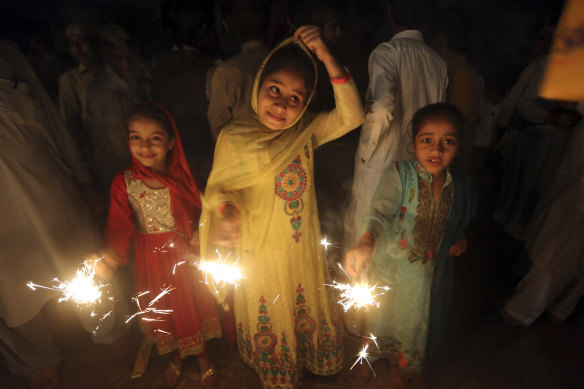 Children from the Pakistani Hindu community hold fireworks during a special ceremony to celebrate Diwali festival.