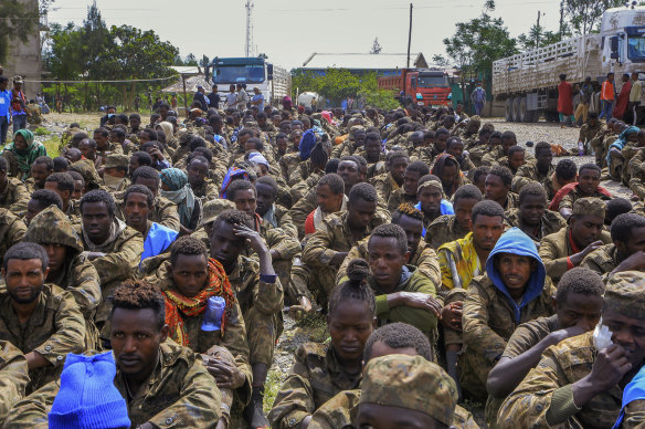 Captured Ethiopian government soldiers and allied militia members sit in rows after being paraded by Tigray forces through the streets in open-top trucks, as they arrived to be taken to a detention centre in Mekele on Friday.