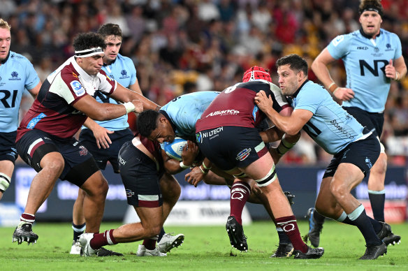 Leafi Talataina of the Waratahs makes a carry against the Reds