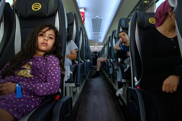 Australians on a bus taking them to a repatriation flight from Israel on Tuesday.