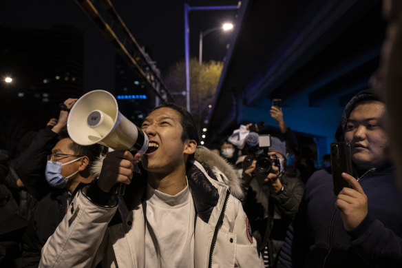 A protester shouts slogans against China’s strict zero-COVID measures in Beijing on Sunday night.