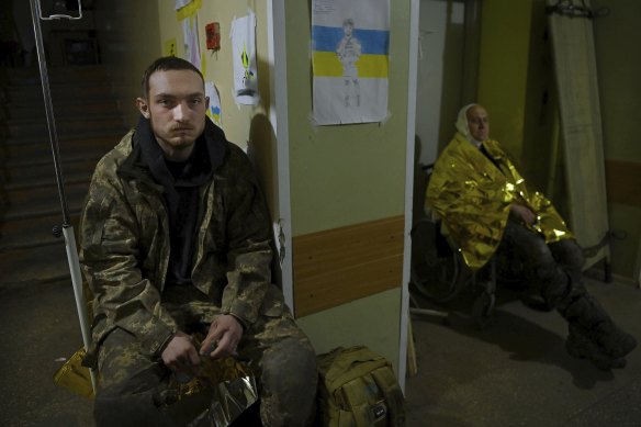 Danylo Turnov waits to be transferred to a hospital where he will be treated for concussion after a fierce battle where grenades and mortars landed in their trench on November 13, his birthday.