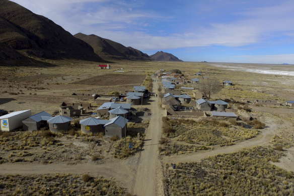 Residents walk along a dirt road in the Urus del Lago Poopo indigenous community, which sits along the salt-crusted former shoreline of Lake Poopo, in Punaca, Bolivia.