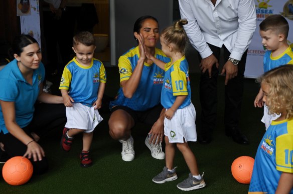 Matildas star Mary Fowler – pictured with Rise & Shine kindergarten pupils in Carlton, NSW – has teamed up with the ASF and Uber to support community sport.